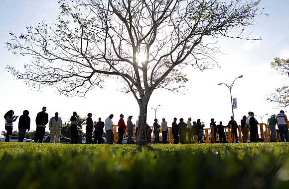 People wait in line looking for jobs during a Job Fair at the Miami Dade College in Miami, Florida, United States.