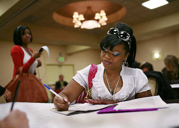 LaShawn McCoy fills out an application for employment as a waitress during a job fair in San Francisco, California, United States.
