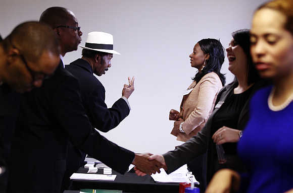 Charles Gates gestures while speaking with a potential employer during the Dr Martin Luther King Jr career fair held by the New York State Department of Labor in New York City.