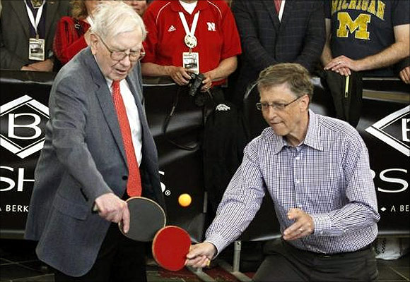 Berkshire Hathaway CEO Warren Buffett (L) plays table tennis with Microsoft Chairman Bill Gates in Omaha.