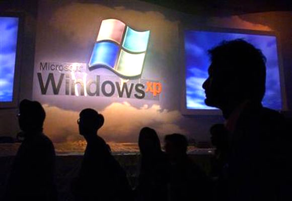 Members of the computer and information technology industries attend the launch of Windows XP operating system in Hong Kong in this November 2, 2001.
