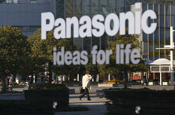 A man is reflected in a sign at Panasonic's showroom in Tokyo.