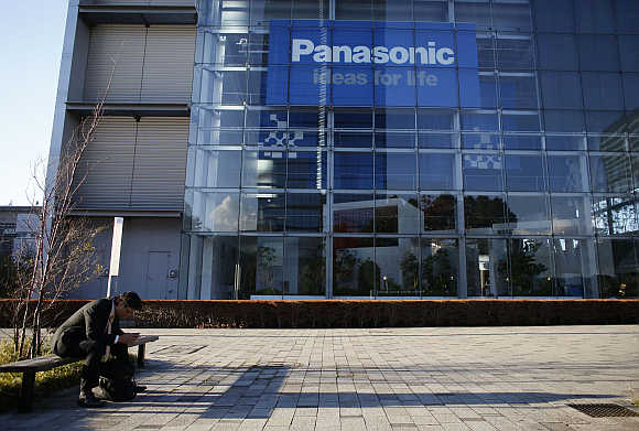A man sits on a bench in front of Panasonic's showroom in Tokyo.