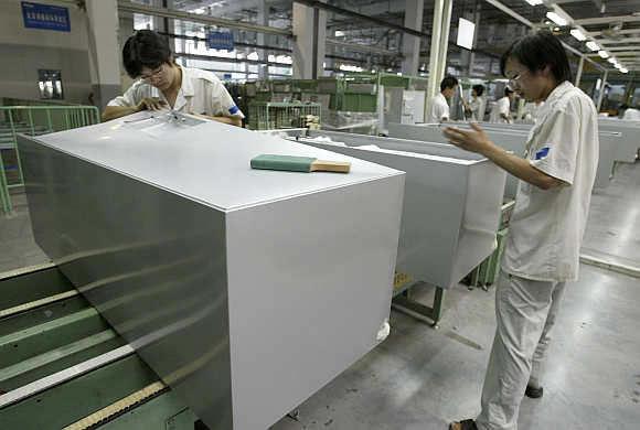 Workers assemble refrigerators at a Haier Group plant in China's eastern port city of Qingdao.