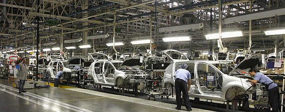 Employees work on the assembly line at the Renault plant in Sao Jose dos Pinhais, Brazil.