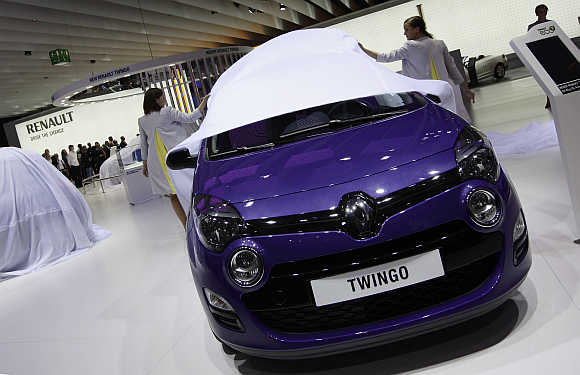 Models at the Renault exhibition booth unveil Renault Twingo in Frankfurt, Germany.