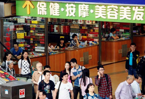 Shoppers walk past small shops at an underground mall in Zhuhai, neighbouring Macau.