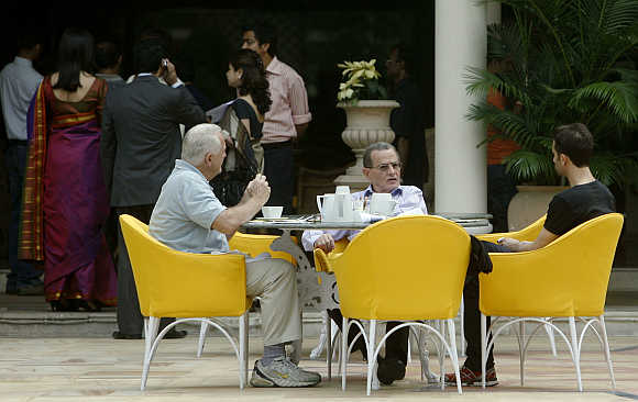 Guests sit at poolside in the Taj Mahal hotel in Mumbai.