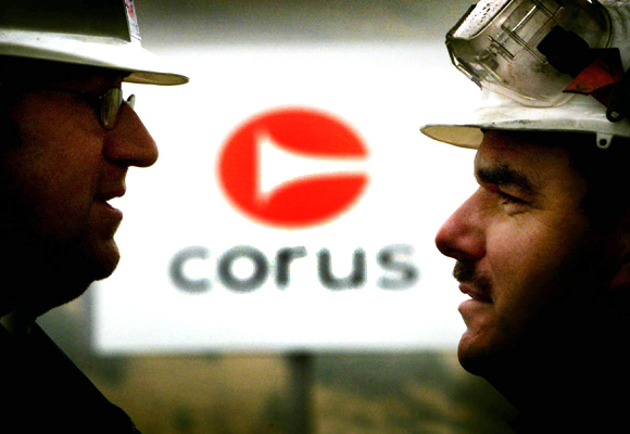 Mike Badham (R) and Michael Hucklebridge, employees of Corus, talk at the entrance to the steel works in Ebbw Vale South Wales.