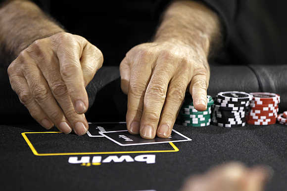 Betting company Bwin Interactive Entertainment logo is pictured with chips and cards on a poker table during an event in Paris, France.
