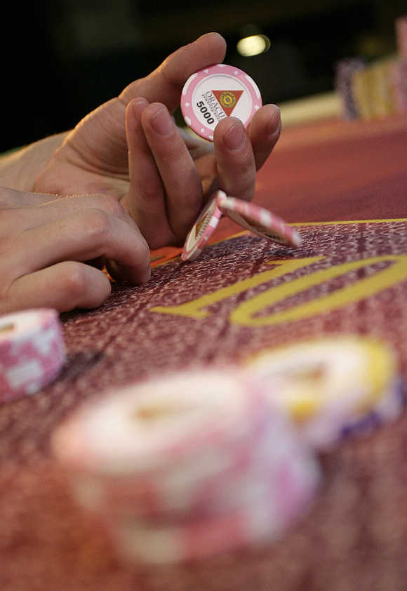 People play poker during the finals of the Russian Masters Poker Cup at the Azov-City gambling zone, some 90km south of Russia's southern city of Rostov-on-Don.
