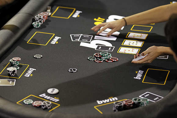 Betting company Bwin Interactive Entertainment logo is pictured with chips and cards on a poker table during an event in Paris, France.