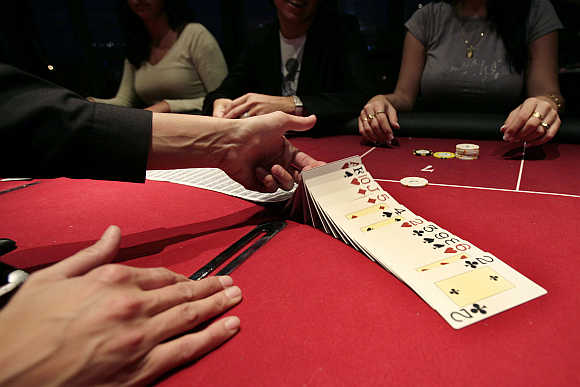 A croupier deals a hand of cards for a poker at the Casino Barriere in Toulouse, France.