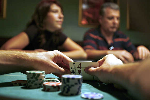 A player checks his cards during a poker game at a Budapest casino in Hungary.