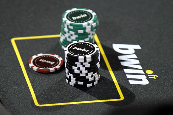 Betting company Bwin Interactive Entertainment logo is pictured with chips on a poker table during an event in Paris.