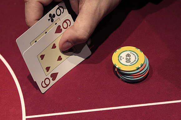 A gambler plays a hand of poker at the Casino Barriere in Toulouse, France.