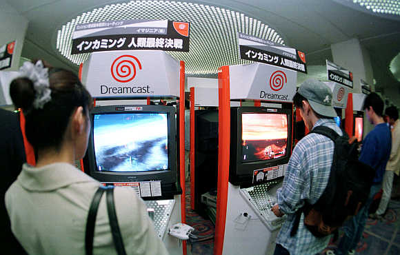 Young Japanese try out computer game maker Sega Enterprises' Dreamcast game machines at a Tokyo hotel.