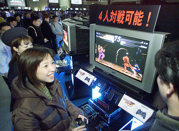 A woman tries out PlayStation in Makuhari, 30km east of Tokyo, Japan.