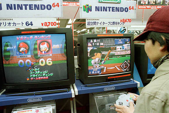 A boy tests his skill on a Nintendo video game in Tokyo's Akihabara electronics district.
