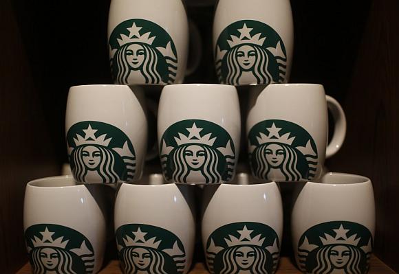 Starbucks coffee mugs are seen on display during the launch of the first Starbucks store in New Delhi.