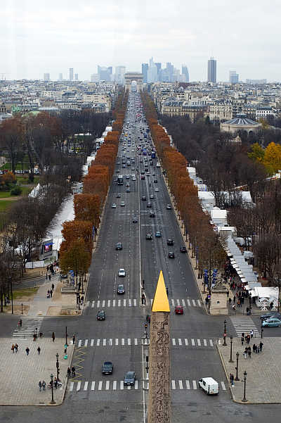 A view of Concorde obelisk, Champs Elysees Avenue and the Arc de Triomphe monument in Paris, France.