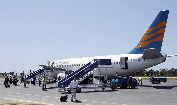 Passengers disembark from a Merpati Nusantara Airlines Boeing 737-228 plane at Dili's Presidente Nicolau Lobato International Airport in East Timor.