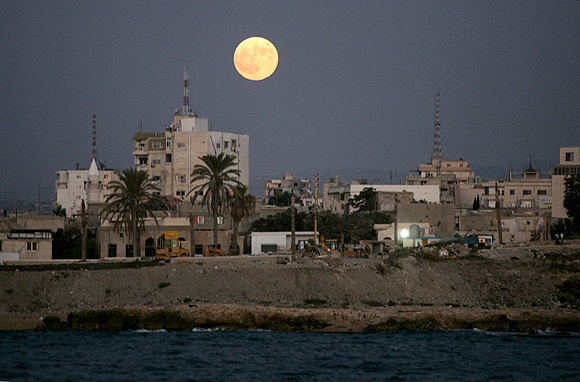 A full moon rises over the port city of Tyre, southern Lebanon.
