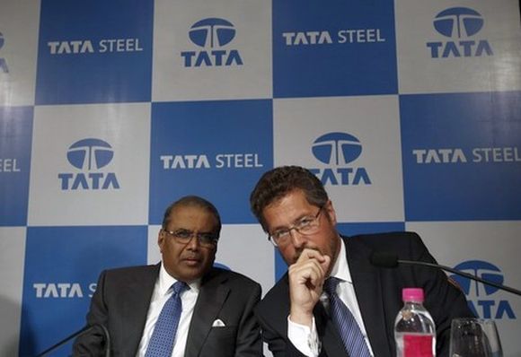Tata Steel's Managing Director Hemant Nerurkar (L) and Tata Steel Europe's Managing Director Karl-Ulrich Koehler speak to each other before a news conference to announce their fourth quarter results.