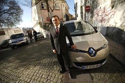 Carlos Ghosn, chairman and chief executive officer of French carmaker Renault, poses next to a Renault Zoe new electric car after a meeting with journalists in downtown Lisbon.