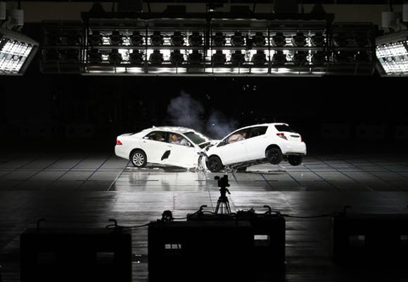 Toyota Motor Corp's Vitz hatchback (R) and flagship Crown sedan are seen colliding in a crash test during the Toyota Safety Technology Media Tour.