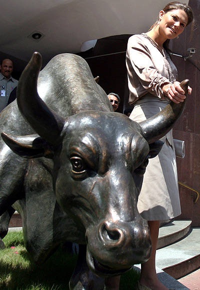 Sweden's Crown Princess Victoria poses with a bronze replica of a bull during her visit to the Bombay Stock Exchange.