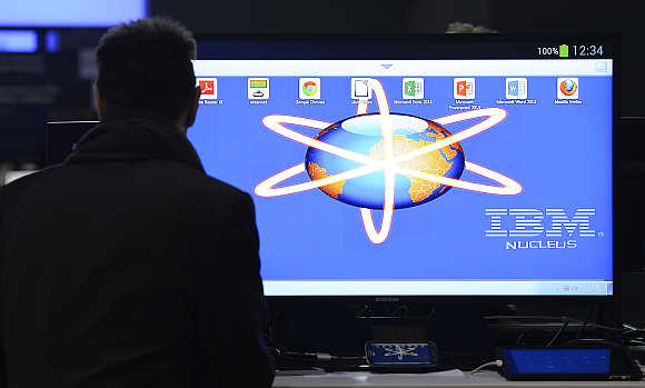 An employee installs a computer at the booth of IBM during preparations at the CeBit computer fair in Hanover, Germany.