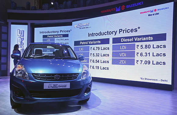 Prices of Maruti Suzuki's Swift Desire are flashed on a screen during its launch in New Delhi.