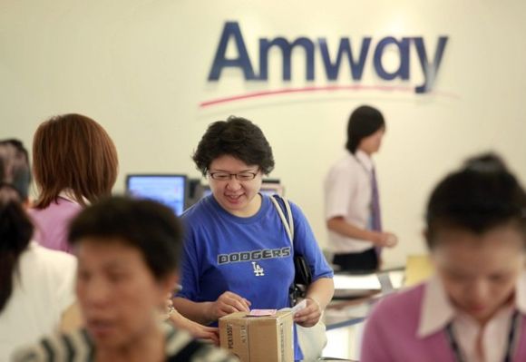 A woman buys Amway products inside the company's sales showroom.