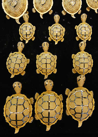 Gold turtles are displayed at a jewellery shop.