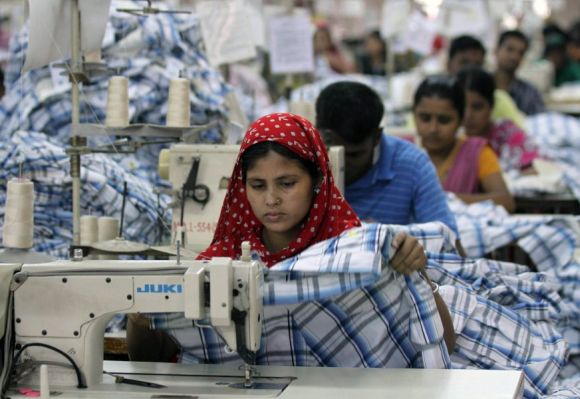 A worker sews inside a garment factory in Ashulia, Bangladesh