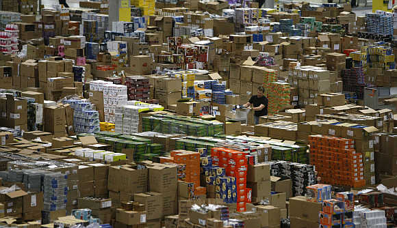 A worker sorts packages at the Amazon warehouse in Leipzig, Germany.