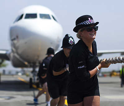 Members of London's Metropolitan Police Ladies tug an Airbus A320 jet for 100 feet during a race at John F Kennedy International Airport in New York. The annual race is a fundraising competition to benefit the charity Joining Against Cancer in Kids.