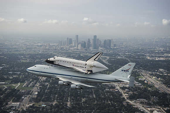 Space shuttle Endeavour, atop Nasa's Shuttle Carrier Aircraft, flies over Houston, Texas.