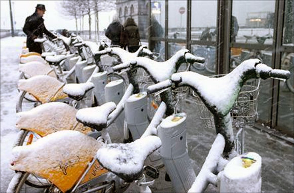 Rental bikes covered with snow in central Brussels.