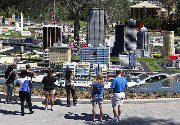 Visitors look at a model of Miami Beach, constructed out of lego bricks, displayed at Legoland Florida during its grand opening celebration in Winter Haven, Florida.