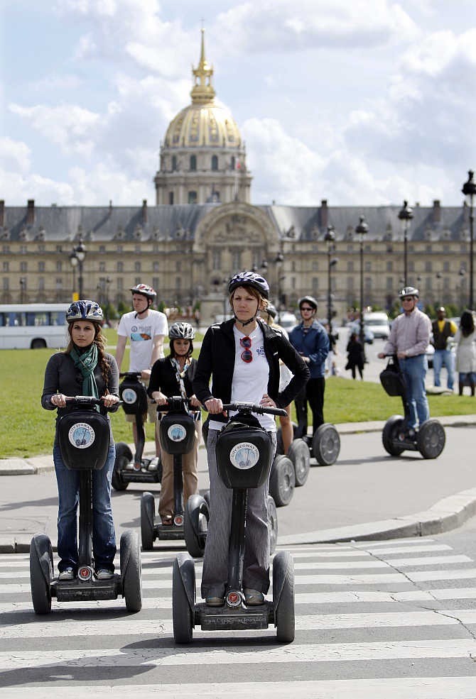 A group of tourists take in the sights of Paris in front of the Invalides on Segways, France.