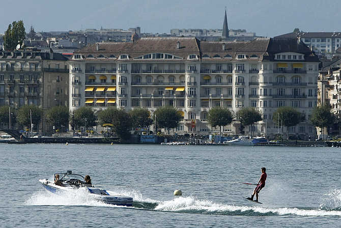 A wakeboarder performs on Lake Leman on a hot autumn day in Geneva, Switzerland.