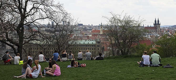 People enjoy the view during a warm spring day at Letna plain above central Prague, Czech Republic.