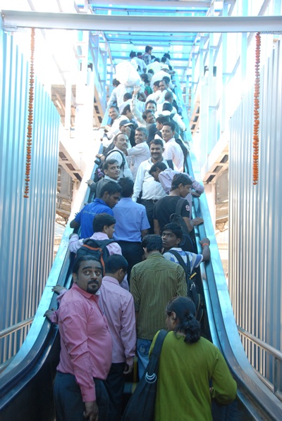 Commuter take the elevator at Mumbai's Dadar station.