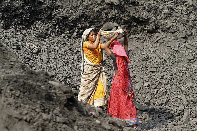Labourers carry coal at a stockyard of an underground coal mine in the Mahanadi coal fields at Dera near Talcher in Orissa. Photo is for representation purpose only.