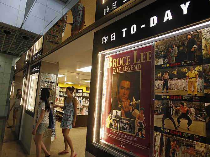 Visitors leave a souvenir store at the Hong Kong Heritage Museum promoting a five-year exhibition on the late Kung Fu legend Bruce Lee.