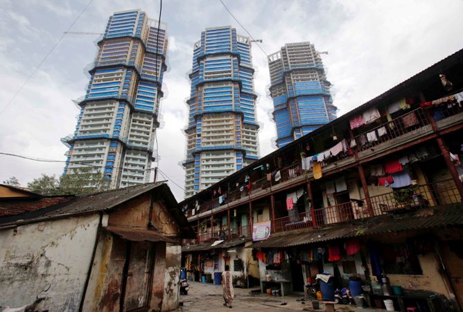 This file photograph shows high-rise residential towers under construction are pictured behind an old residential building in central Mumbai.