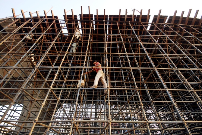 Labourers erect scaffolding at a construction site in Hyderabad.