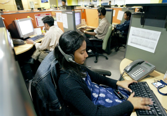 Indian employees at a call centre provide service support to international customers, in the southern city of Bengaluru.